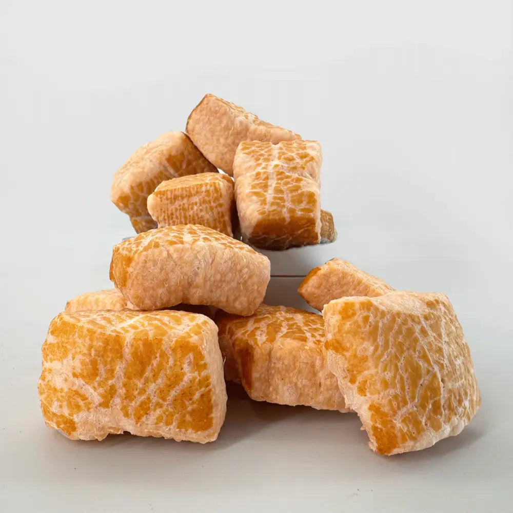 Pile of yak cheese puff pieces on a white background